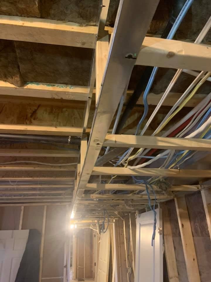 Water supply lines running through open basement ceiling joists