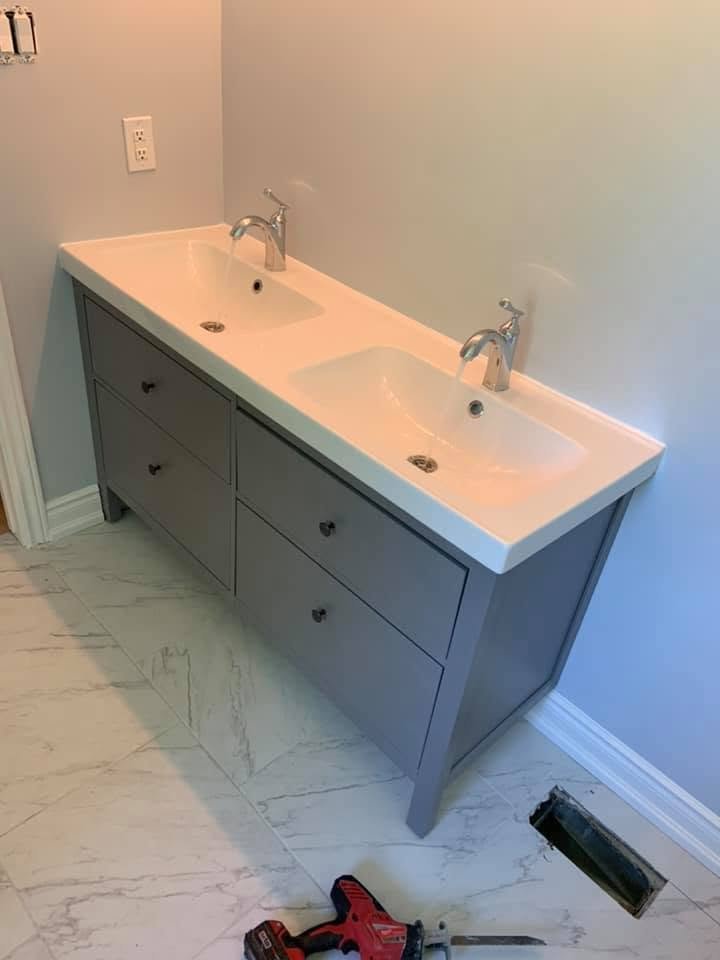 Newly installed double-sink bathroom vanity with two faucets